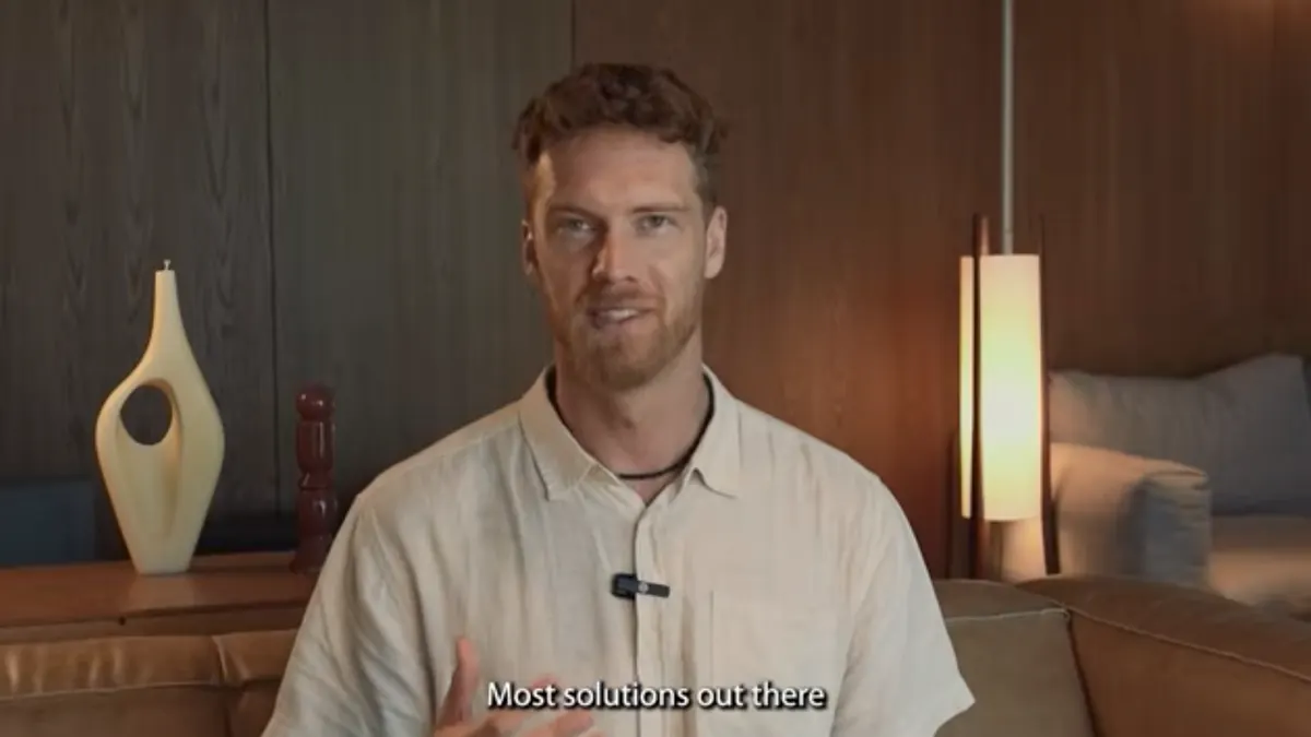 A still from the Kickstarter film: Hannes talking to camera in a warm, wood panelled room.